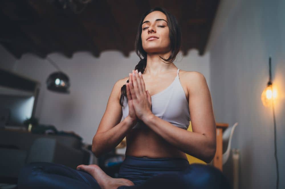 Young woman meditating at home.